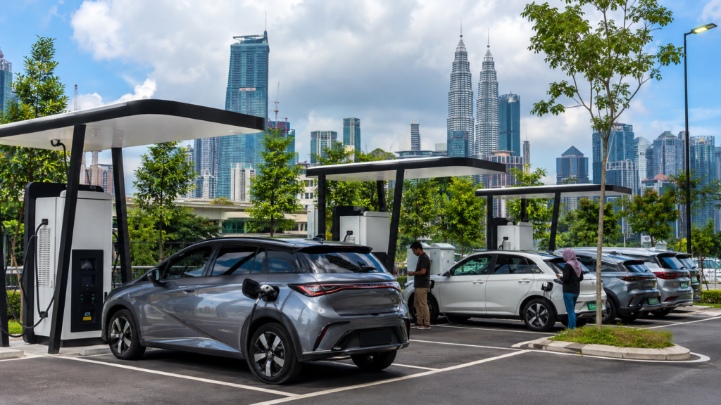Electric vehicles using public charging stations in a modern Malaysian urban area