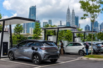 Electric vehicles using public charging stations in a modern Malaysian urban area