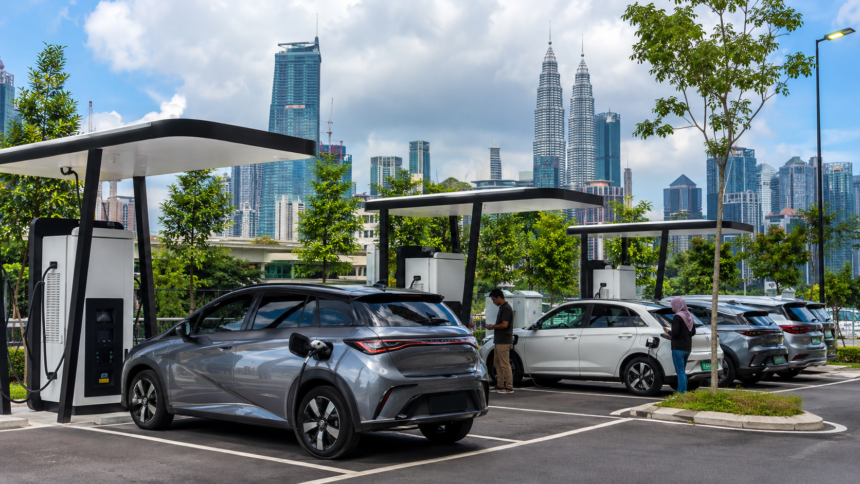 Electric vehicles using public charging stations in a modern Malaysian urban area