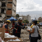 Rescue workers search damaged buildings after the Venezuela earthquake as aid response continues