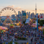 Crowds enjoying midway rides and attractions at the Canadian National Exhibition in Toronto.