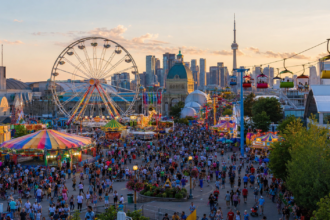 Crowds enjoying midway rides and attractions at the Canadian National Exhibition in Toronto.