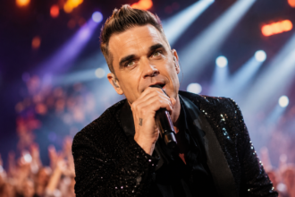 Robbie Williams performing live, representing his best-known songs and solo hits