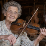Violet Hensley playing a handmade fiddle